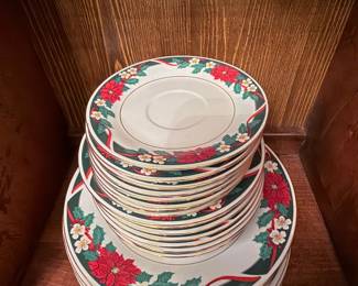 Vintage Christmas Dinnerware Set – Festive holiday dinnerware featuring a classic poinsettia, holly, and ribbon pattern with elegant gold trim. Includes assorted dinner plates, salad plates, and saucers, perfect for holiday entertaining or seasonal display. A beautiful addition to any Christmas table setting.