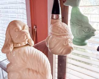 Vintage Decorative Glass & Ceramic Collection – Eclectic assortment of vintage décor including a white ceramic spaniel figurine, jadeite-style fish vase, novelty figural decanter, and decorative ceramic head vase. A fun collection for vintage glass lovers, mid-century décor enthusiasts, and unique home décor collectors. Sold individually unless noted.
