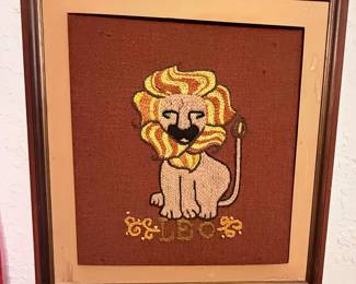 Framed Handcrafted Lion Needlepoint Art – Vintage framed needlepoint featuring a whimsical lion with a colorful mane on a rich brown background. A charming handmade piece perfect for a nursery, child's room, or vintage-inspired wall décor. Ready to hang.