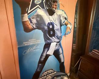 Dallas Cowboys Troy Aikman Advertising Display – Life-size cardboard floor display featuring Hall of Fame quarterback Troy Aikman in his Dallas Cowboys uniform. Produced as a Miller Lite promotional display with Texas Stadium branding. A fantastic collectible for Cowboys fans, sports memorabilia collectors, or game room décor. Stands approximately life-size. Sold as found.