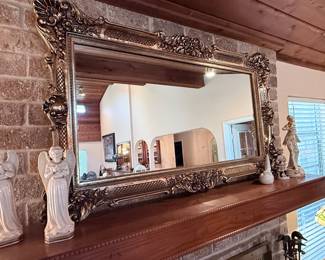 Ornate Framed Wall Mirror – Stunning oversized wall mirror featuring an intricately carved decorative frame with an antique gold and bronze finish. Rich scrollwork, floral motifs, and traditional detailing make this an elegant statement piece for an entryway, living room, dining room, or above a fireplace mantel. Ready to hang.