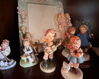 Vintage Hummel-Style Figurine Collection – Charming assortment of porcelain figurines featuring children, angels, musicians, and storybook scenes in hand-painted finishes. A delightful collection for curio cabinets, traditional home décor, or collectors of Hummel-style figurines. Sold individually unless noted.