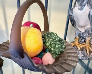 **Decorative Fruit Basket Figurine** – Vintage-style decorative resin fruit basket featuring assorted fruit in a woven shell-shaped basket with arched handle. A charming accent piece for farmhouse, cottage, or traditional home décor.