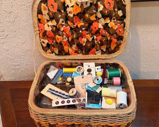 Vintage Sewing Basket with Sewing Notions – Charming woven sewing basket featuring a floral fabric interior and matching exterior trim. Includes an assortment of sewing supplies such as thread, buttons, needles, pins, trim, and other notions. A wonderful find for quilters, crafters, sewists, or vintage sewing enthusiasts. Sold as found with contents.