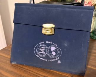 Vintage Labor Council Portfolio Briefcase – Vintage navy blue portfolio briefcase with a snap closure and carrying handle, featuring the **Labor Council for Latin American Advancement (LCLAA)** logo. Ideal for document storage, meetings, or as a unique piece of labor union and political memorabilia. A great collectible for historians, union memorabilia enthusiasts, or vintage office accessory collectors. Sold as found.