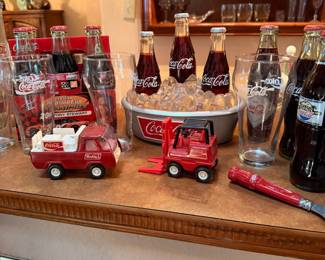 Coca-Cola Collectibles & Barware Collection – Fun assortment of Coca-Cola memorabilia including collectible glass bottles, branded drinking glasses, miniature delivery truck and forklift collectibles, serving bowl, NASCAR commemorative items, bottle opener, and other advertising collectibles. A great collection for Coca-Cola enthusiasts, Americana collectors, or retro home bar displays. Sold individually unless noted.