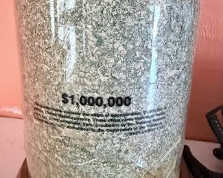 $1 Million Shredded Currency Display – Unique conversation piece featuring a clear display dome filled with authentic shredded U.S. currency valued at **$1,000,000** before destruction. Mounted on a wooden base, this novelty display makes a fun addition to an office, game room, or collector's display shelf.