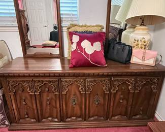 **Vintage Carved Wood Dresser with Twin Mirrors** – Beautiful vintage dresser featuring richly carved cabinet doors and decorative hardware, topped with matching dual framed mirrors. Offers ample concealed storage and timeless traditional styling. A stunning statement piece for a bedroom, entryway, or dining room. Contents not included unless noted.
