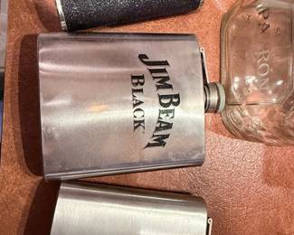 Vintage Stainless Steel Hip Flask Collection – Assorted stainless steel hip flasks including branded examples such as Jim Beam Black and decorative novelty designs. Great for barware collectors, man caves, gifts, or outdoor adventures. Sold individually unless noted.