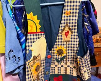 Vintage Handcrafted Appliqué Vest – Whimsical handcrafted patchwork vest featuring gingham fabric, colorful appliqué sunflowers, birdhouse, heart, sunshine, and button accents. A charming piece of wearable folk art that's perfect for fall, country fairs, gardening, quilting enthusiasts, or anyone who loves cottage and country style. Great for collectors of handmade vintage clothing. Sold as found.