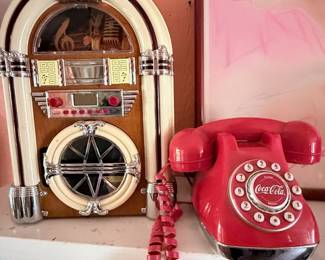 Retro Jukebox & Coca-Cola Rotary Phone – Nostalgic collection featuring a decorative tabletop jukebox and a vintage-style Coca-Cola rotary telephone. Perfect for a game room, diner-inspired space, or collectors of retro Americana décor. Sold separately unless noted.