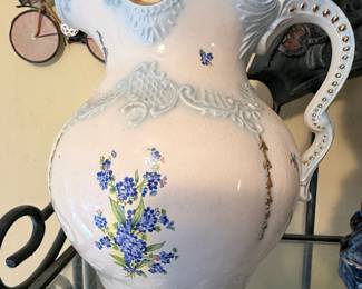 **Vintage Ceramic Pitcher with Blue Floral Motif** – Elegant white ceramic pitcher featuring embossed detailing, a scalloped rim, and delicate blue floral accents. A beautiful farmhouse, cottage, or shabby chic décor piece, perfect for displaying fresh or dried flowers.