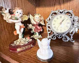 Cherub Figurines & Vintage Mantel Clock Collection – Decorative assortment featuring cherub and angel figurines, an ornate vintage-style quartz mantel clock with Roman numerals, and collectible religious accents. A charming collection for traditional, Victorian, or devotional home décor. Sold individually unless noted.