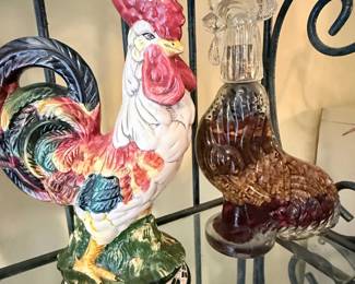 **Assorted Rooster & Farmhouse Décor Collection** – Charming assortment of rooster-themed décor including ceramic figurines, frosted glass rooster, cast iron rooster, rooster accent plates, white ceramic birds, lion figurines, and a lucky shamrock piggy bank. Great selection for farmhouse, country, or rooster collectors. Sold individually unless noted.