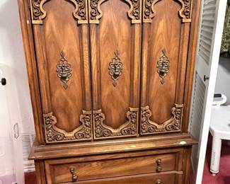 Vintage Carved Wood Armoire Entertainment Cabinet – Beautiful traditional armoire crafted from richly grained wood with ornate carved door panels, decorative hardware, and lower storage drawers. Perfect for use as an entertainment center, media cabinet, or versatile storage piece in a living room or bedroom. A timeless statement piece with classic craftsmanship. Contents not included unless noted.