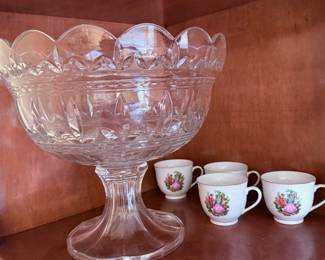 Large Cut Glass Pedestal Bowl & Floral Tea Cups – Elegant cut glass pedestal bowl featuring a scalloped rim and pressed glass design. Displayed with a set of delicate floral tea cups. A beautiful choice for entertaining, display, or vintage-inspired décor. Sold separately unless noted.