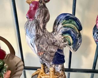 **Assorted Rooster & Farmhouse Décor Collection** – Charming assortment of rooster-themed décor including ceramic figurines, frosted glass rooster, cast iron rooster, rooster accent plates, white ceramic birds, lion figurines, and a lucky shamrock piggy bank. Great selection for farmhouse, country, or rooster collectors. Sold individually unless noted.