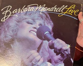 Barbara Mandrell Live Vinyl Record – Vintage live LP featuring country music star Barbara Mandrell performing many of her biggest hits. A great addition for country music fans, Barbara Mandrell collectors, and vintage vinyl enthusiasts. Sold as found; condition not verified.