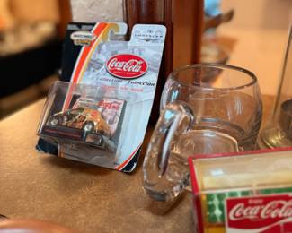 Coca-Cola Collectibles & Glassware – Assortment of Coca-Cola memorabilia including a collectible Matchbox Coca-Cola die-cast race car in its original packaging, a heavy glass mug, and additional Coca-Cola advertising collectibles. A great selection for Coca-Cola collectors, die-cast enthusiasts, or retro Americana displays. Sold individually unless noted.