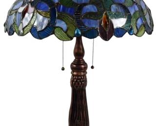 192 - Tiffany Style Stained Glass Table Lamp 28" (Description): Tiffany style stained glass table lamp featuring a dome shade with vibrant blue, green, and amber glass panels arranged in a floral and leaf motif. The shade has a scalloped edge and is supported by a bronzed metal base with ornate Art Nouveau styling, including a fluted column and decorative footed pedestal. The lamp features dual pull chains for operation. Measures 28 inches tall.