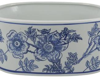 171 - Small Blue & White Floral Ceramic Planter (Description): Small blue and white ceramic planter featuring a lovely floral and butterfly design in the traditional Chinese export style. The oval-shaped vessel has two small loop handles on either side and rests on a slightly raised foot. Decorated with detailed botanical motifs including large blooming flowers and delicate foliage. Measures 5 1/2" x 13" x 9".