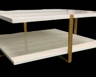 4185 - Chelsea House Ribbed Cocktail Table (Description): 17 x 40 x 40, Sleek, sophisticated cocktail table featuring two levels held together by ribbed metal brackets in antique gold. Equally at home in contemporary or traditional environments. Designed by Elizabeth Wicker.