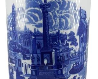 111 - Large Blue and White Umbrella Vase 17"x8" (Description): Large blue and white cylindrical vase featuring classic transferware-style decoration. The vase is adorned with scenic imagery depicting a European cityscape with an ornate monument or column as the central focus, surrounded by figures on horsebackand pedestrians in period dress. The upper border features decorative cartouches with architectural vignettes. Measures 17 inches tall by 8 inches in diameter.