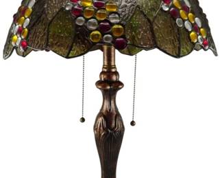 181 - Tiffany Style Stained Glass Table Lamp 24" (Description): Tiffany style stained glass table lamp featuring a decorative grape and leaf motif. The shade displays an array of colorful glass cabochons in red, amber, yellow, and clear tones against green textured glass panels with bronze-toned leading. The lamp sits on a cast metal base with an Art Nouveau-inspired organic design and bronzed finish. Features dual pull-chain switches. Measures 24 inches tall.