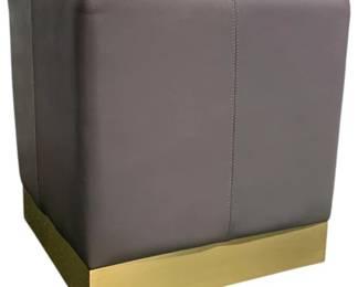 4194 - Wildwood Dorian Gray Stool (Description): 18 x 18 x 18, Capable of serving many purposes, the trend setting Dorian Gray Pouf features a square design of stunning gray leather. A stainless steel base with a warm antique brass finish gives support. Easily transportable for use as a footstool or extra seating throughout your home or office.