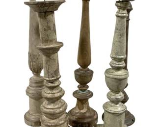 2429 - 5 Candle Prickets 21" - 25" Tall (Description): A collection of five candleholders in varying styles and finishes. The pieces feature turned baluster designs with decorative carved details. Heights range from 21 to 25 inches tall.