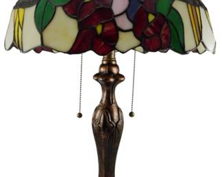 185 - Tiffany Style Stained Glass Table Lamp 24" (Description): A Tiffany style stained glass table lamp featuring a colorful floral dome shade with red roses, pink and purple blooms, green leaves, and yellow accents against a cream background. The shade has a scalloped edge and sits atop a cast metal base withan antique bronze finish and Art Nouveau inspired design. The lamp operates with dual pull chain switches. Electric/electronic/mechanical item - No