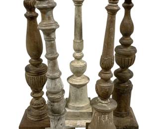 2428 - 5 Candle Prickets 19.5" - 21" Tall (Description): A collection of five candleholders in varying styles and finishes. The pieces measure 19.5" - 21" tall and feature turned wooden construction with weathered painted surfaces. Each candleholder has a pricket spike at the top for securing candles.