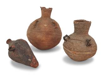 1171 Three Paiute basketry vessels Late 19th/early 20th century; Great Basin A group comprising two coiled globular basketry jars, each with multistrand braided horsehair handles, one with a sinew cord, as well as a small twined tapered conical bottle-neck vessel sealed with pine resin pitch, with one multistrand braided horsehair handle 3 pieces Larger jar height 12 in., diameter 10 in.; smaller jar height 9 1/4 in., diameter 8 in.; tapered jar height 10 1/2 in., diameter 5 1/4 in. approximately Estimate: $300 - $500