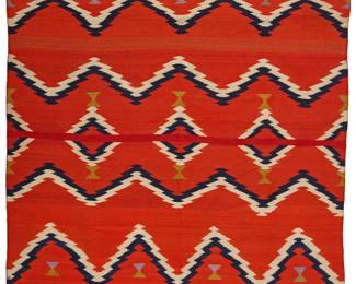1207 A Diné (Navajo) Late Classic sarape Circa 1875-1885 Woven in red, cream, indigo, purple, and yellow wool with multiple bands of serrated barbed zigzags and floating serrated diamonds to center 4 ft. 10 in. x 3 ft. 6 in. approximately Estimate: $4,000 - $6,000
