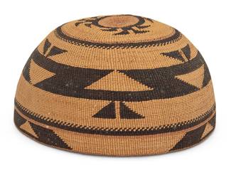 1160 A Hupa/Yurok/Karuk polychrome basketry hat Early/mid-20th century; Northern California A twined hat with imbricated triangular and hooked banding to sides and clusters of triangular 'foot' motifs to crown Height 3 1/2 in., width 6 1/2 in., depth 6 1/4 in. Estimate: $500 - $700