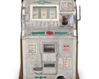 1306 A Mills 'Bell Fruit' slot machine Second quarter 20th century The one-cent machine with three reels, housed in an enameled metal and wood case Inscribed at front in the casting: BD NOVELTIES / LOS ANGELES CAL; numbered to upper components in the metal: MVC1375 / 148069 Height 24 3/4 in., width 16 1/2 in., depth 15 1/2 in. Estimate: $800 - $1,200