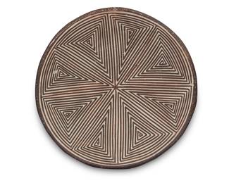 1050 Lucy M. Lewis (1890-1992, Acoma Pueblo) A diminutive pottery tray Decorated with black fine-line geometric design on white slip ground Signed in slip to underside: Lucy M. Lewis / Acoma, N.M. Height 3/4 in., diameter 4 in. Estimate: $200 - $400
