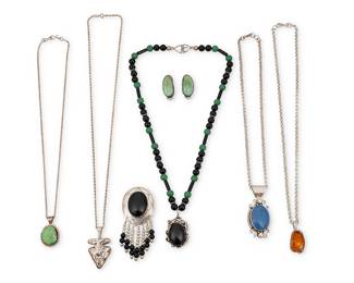 1401 Seven Southwest sterling silver jewelry items Late 20th century Comprising a single strand necklace of onyx and green stone beads suspending a set onyx cabochon with applied silver feathers and wire overlay accents, as well as four further pendants, each on an associated chain, including a set amber pendant by Nusie Henry Belon (Diné [Navajo]), a small set variscite pendant, a set lapis lazuli blue pendant/brooch with set pearls, and a cast sterling silver arrowhead pendant, together with a concho-style stamped sterling silver and set onyx pendant/brooch with multiple bead dangles and a pair of turquoise earrings by Esther Wood (b. 1946, Diné [Navajo] Four stamped for artist: A / AJ / Nusie [script] / Esther [etched signature]; five further stamped for Sterling, one stamped: Navajo 8 pieces Necklace 22 x 2 3/4 in.; pendants/brooches 3 1/2 in. to 1 1/2 in.; chains 24 in. to 17 1/2 in.; earrings 1 1/4 in. 204.9 grams gross Estimate: $300 - $500