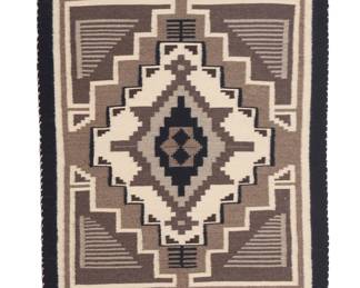1285 A Diné (Navajo) Two Grey Hills rug Late 20th century Woven in browns, greys, black and cream wool with a central elaborate stepped diamond and stepped motifs to the corners 2 ft. 6 in. x 2 ft. 11 1/4 in. approximately Estimate: $200 - $400
