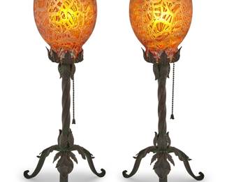 1100 A pair of Durand Moorish crackle glass shades 1920s Each on associated wrought-iron tripod base issuing a single light, electrified 2 pieces Height of each overall 22 1/4 in.; height of bases 15 3/4 in., width 8 1/2 in., depth 7 1/2 in.; height of shades 9 in., diameter 5 7/8 in. Estimate: $600 - $800