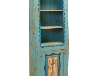 1348 A New Mexican-style painted wood cabinet Late 20th/early 21st century With two shelves above a painted Yei figure to cabinet door, opening to reveal a single shelf Height 73 in., width 27 3/4 in., depth 13 1/4 in. Estimate: $400 - $600