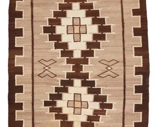 1226 A Diné (Navajo) Two Grey Hills rug Early 20th century With conjoined stepped diamonds and floating figural motifs within a denticulated border, woven in dark brown, cream, natural grey, and ochre wool 6 ft. 11 1/2 in. x 4 ft. 7 1/2 in. Estimate: $600 - $800