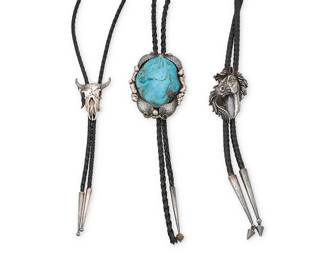 1327 Three Southwest-style sterling silver bolo ties Late 20th century Featuring a sterling silver and carved turquoise-colored stone horse bolo, a sterling silver horse head portrait bolo, and a sterling silver steer skull bolo, each mounted on a braided leather cord with silver tips Variously marked for maker and for sterling: S.T.C. / G 3 pieces Largest bolo 3 1/4 x 2 1/2 in., cord 37 in.; smallest 2 x 1 1/2 in., cord 37 in. 221.2 grams gross Estimate: $200 - $400