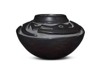 1073 Barbarita Tafoya-Naranjo (1917-1984, Santa Clara Pueblo) A blackware pottery Avanyu-motif olla jar Deeply carved with Avanyu to shoulder Incised signature to underside: Barbarita / Santa Clara / Pueblo Height 5 7/8 in., diameter 9 3/4 in. Estimate: $800 - $1,200