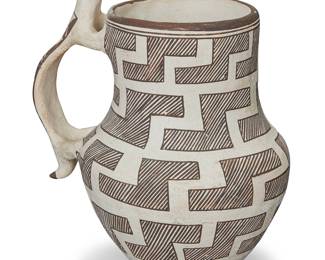 1053 Marie Z. Chino (1907-1982, Acoma Pueblo) A pottery effigy water pitcher With figurative handle decorated with fine-line black Anasazi Revival stepped design on white slip ground Signed to the underside: Marie Z. Chino / Acoma, N M Height 8 1/4 in., width 7 in., depth 5 3/4 in. Estimate: $400 - $600