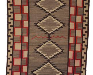 1265 A Diné (Navajo) regional rug First half 20th century Woven in grey, red, brown, and cream wool with a central column of stacked sawtooth diamonds and a red zigzag line, all within two crenelated inner borders and with a meandering stepped border to the long side edges 7 ft. 5 in. x 4 ft. 9 in. approximately Estimate: $700 - $900