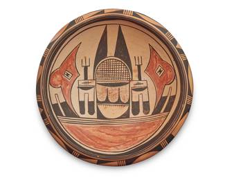 1029 A Hopi polychrome yellowware pottery low bowl Mid-20th century Possibly Nampeyo family made, with red and black figural designs to interior on yellow ground, with banded geometric motifs to shoulder exterior Unmarked Height 3 1/2 in., diameter 9 7/8 in. Estimate: $300 - $500