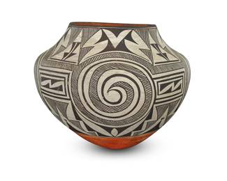 1049 Lucy M. Lewis (1890-1992, Acoma Pueblo) A polychrome pottery jar, circa 1940 Decorated with black conjoined fine-line spirals separated by stepped and rectangular elements on white slip above a terracotta wash and puki indentation Signed in slip to base: Lucy M Louis [sic] / Acoma NM. Height 9 1/8 in., diameter 11 3/8 in. Estimate: $3,000 - $5,000