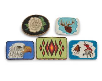 1123 Five contemporary Native American polychrome beaded belt buckles Late 20th/21st century Comprising five pictorial buckles featuring various motifs including an eagle head on a blue ground, a stag on a frosty blue and white ground, a bison hunter on a white and blue ground, and a white rose on a black ground, as well as a large buckle with geometric ombré stepped diamond motifs on a pale green ground, each with hide backing Three with maker's mark verso 5 pieces Largest 3 1/2 x 4 5/8 in.; smallest 2 3/4 x 3 5/8 in. Estimate: $200 - $300