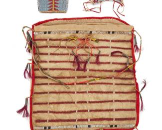 1121 Three Lakota (Sioux) beaded hide pouches Late 19th/early 20th century; Great Plains Comprising a large buffalo hide and cotton fabric pouch with banded polychrome beadwork to front, a quill-wrapped strap, and tassels with tin cone and horsehair ends; a petite strike-a-light style bag of buffalo hide, beaded on one face with geometric motifs; and a tall pouch with stacked triangle arow motifs to each side 3 pieces Largest 11 1/2 x 11 in.; smallest 4 x 3 1/2 in. Estimate: $1,000 - $1,500